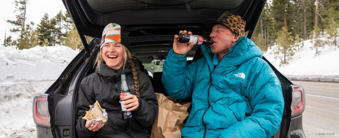 “Jim Morrison and Michelle Parker share a laugh over some food and drink while resting on their fourth and last day of circumnavigating Lake Tahoe. They were in good spirits for two people who were physically destroyed. Over the four days, I met them at various locations around the lake to supply water, some food and a charge for their phones.” Photo: Ming Poon