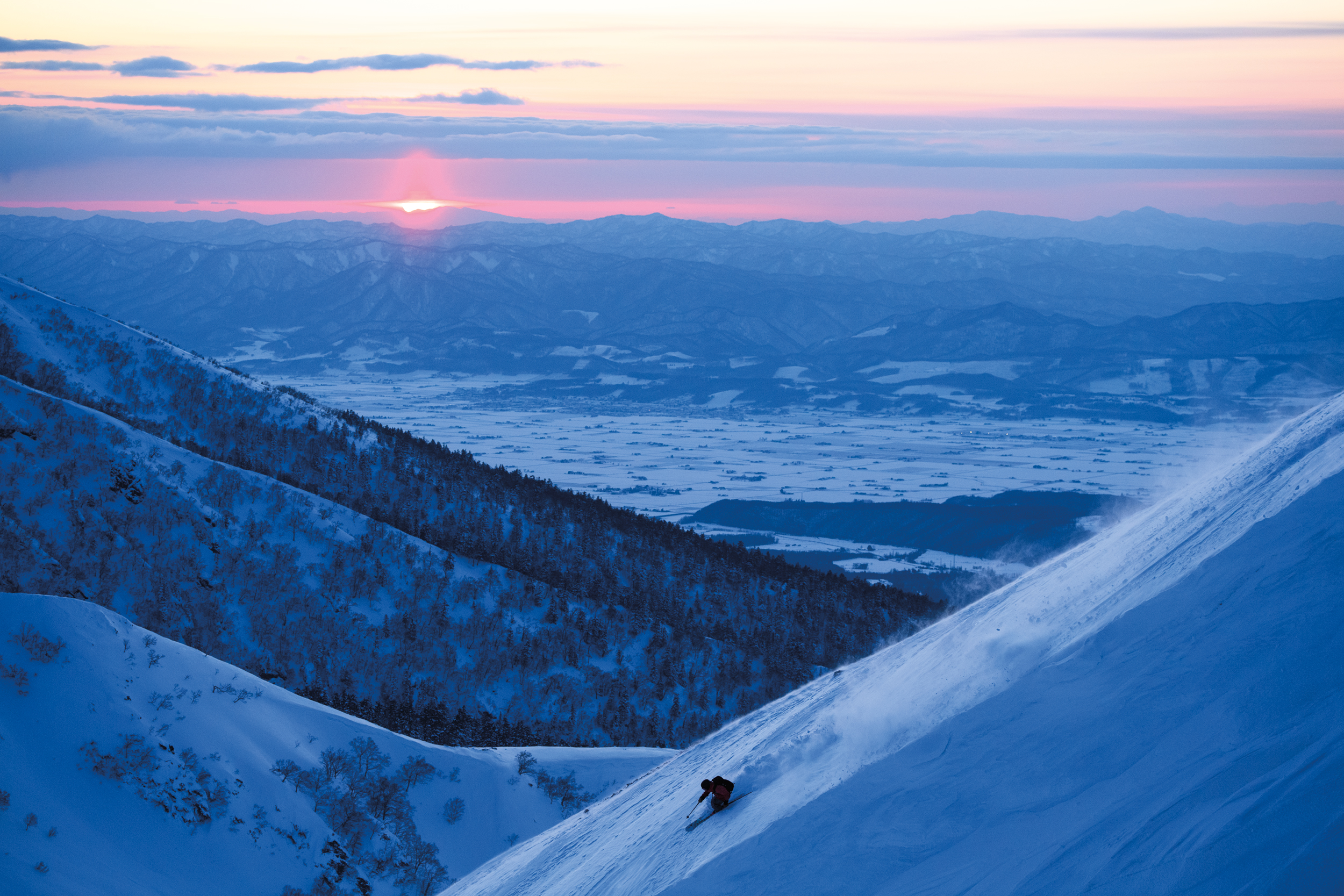 “The weather forecast called for sun all day long in Kamifurano on Hokkaido, Japan. Hidemitsu Okada and I started skinning before sunrise and returned to the car for a lunch break. We chatted with locals to find out more about the area, then we went back out in the evening for a few turns in the cold air and a beautiful twilight session.” Photo: Takahiro Nakanishi 