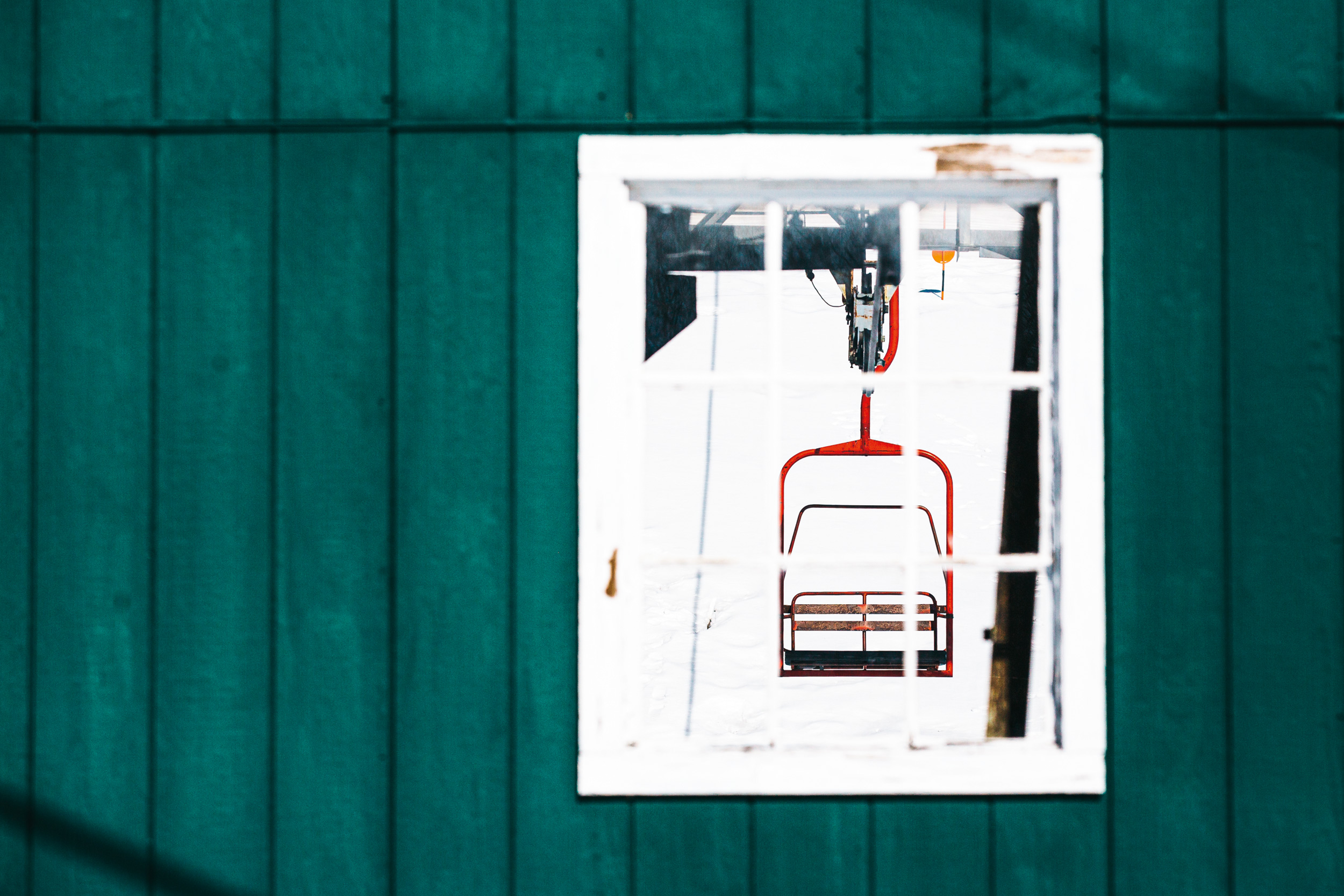 “What’s a New England ski area without a bright red chairlift? I spotted this humble two-seater at Black Mountain, NH, in 2021. Black Mountain is the epitome of a mom-and-pop ski area. While the resort is small, it clearly means a lot to the families that call this place home. The parking lot bumps right up to the ski slope, and many skiers had their cars parked at the snow’s edge with their tailgates overflowing like a day on the beach. There were coolers, lunches from home, lots of party shirts and tiny tots running wild in their ski boots. Parents lounged in beach chairs as kids lapped the main lift on their own, occasionally heading back to base camp for a slice of watermelon.” Photo: Katie Lozancich