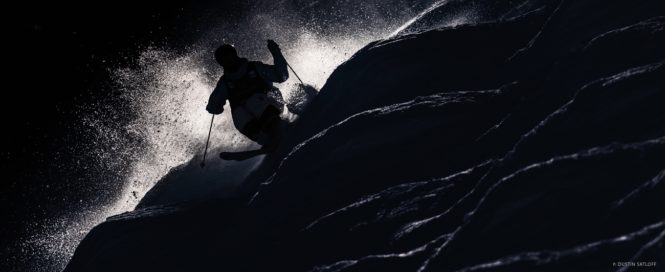 Porter Huff takes a training run ahead of the Deer Valley Moguls World Cup [in Utah] in 2024. Something I love about covering training days is the increased freedom and access to the event. Another bonus is the steady stream of athletes coming down the hill. For this image, I waited for someone to use the far right course in order to frame the backlit moguls in the foreground. Photo: Dustin Satloff